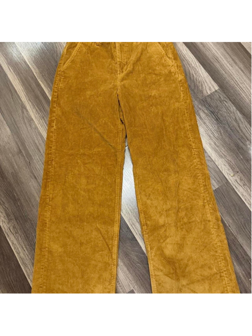 Mustard golden corduroy wide leg pants with a retro 70s-inspired silhouette